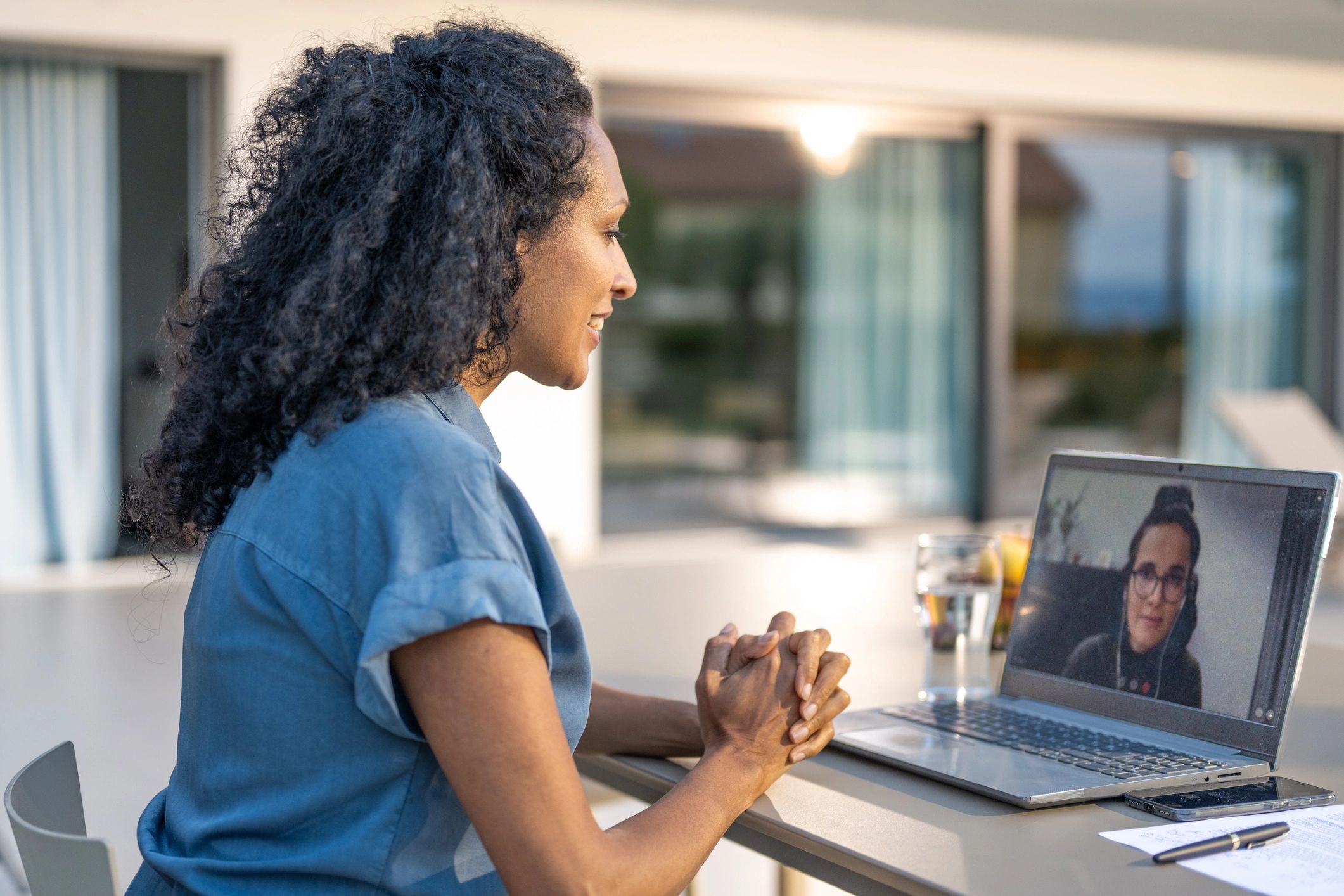 Woman attending an online spiritual consultation on laptop